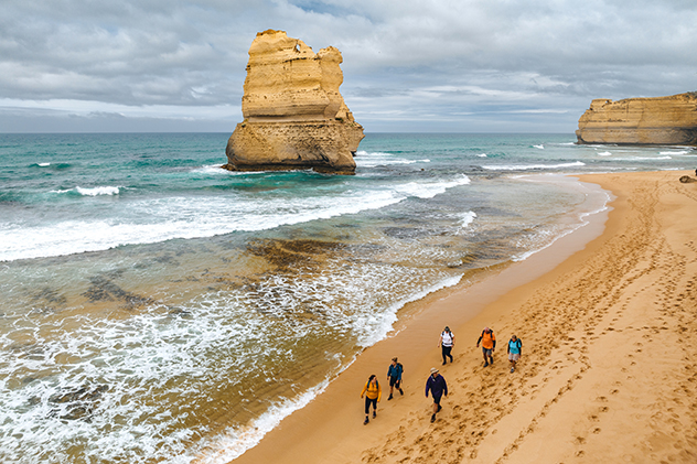 People walking on the beach near the 12 Apostles.