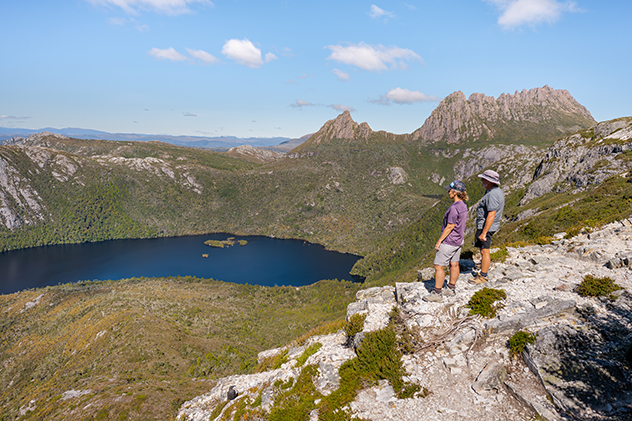 Two people at a lookout overlooking a lake