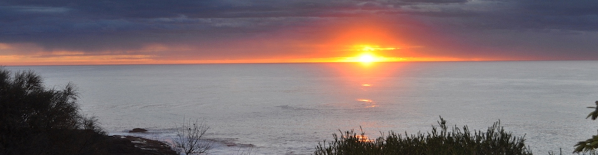 Merimbula coastline sunrise NSW view from the shore with sunrise on the water