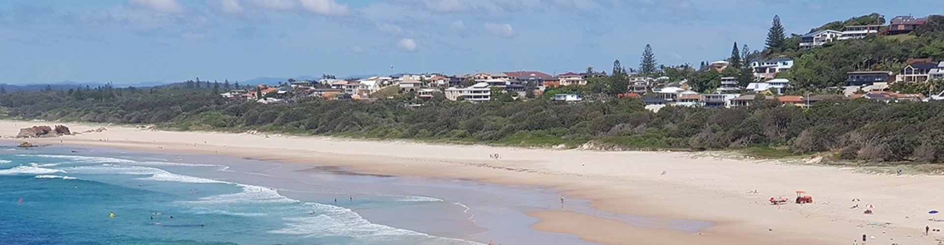 Port Macquarie beach viewed from Tacking Point Lighthouse NSW arial view of people swimming in the sea and on the beach