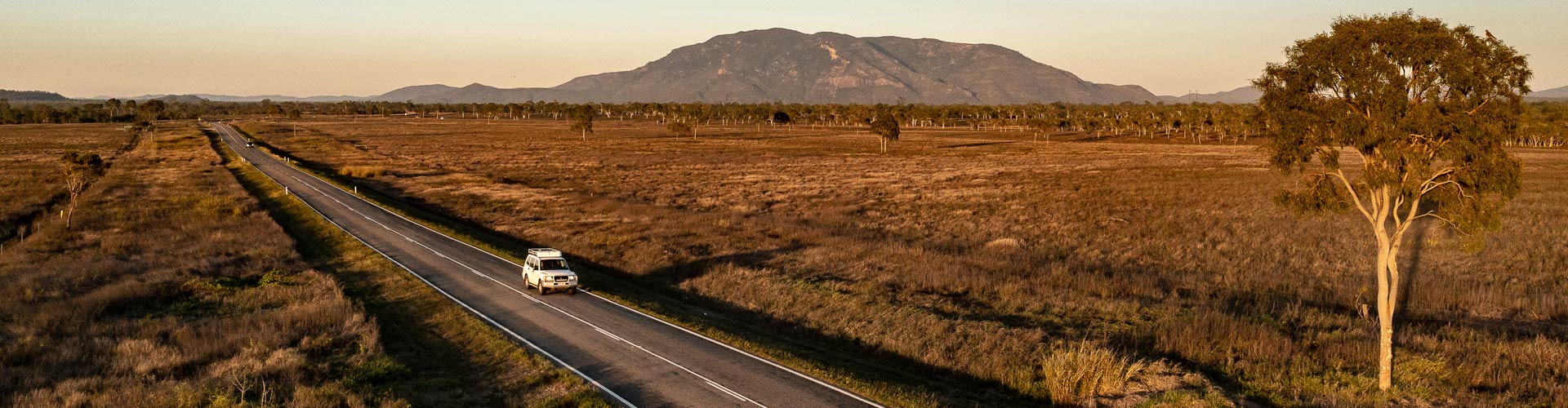 Aerial view of a 4WD driving on an outback Queensland road