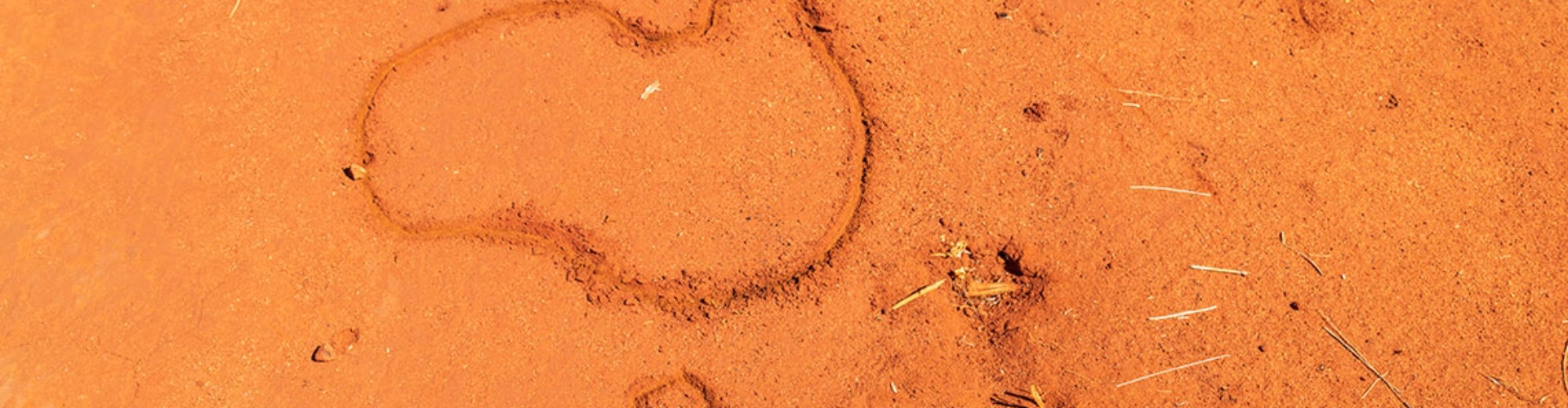 Top reasons to take a road trip outline of australia and tasmania drawn in red dirt