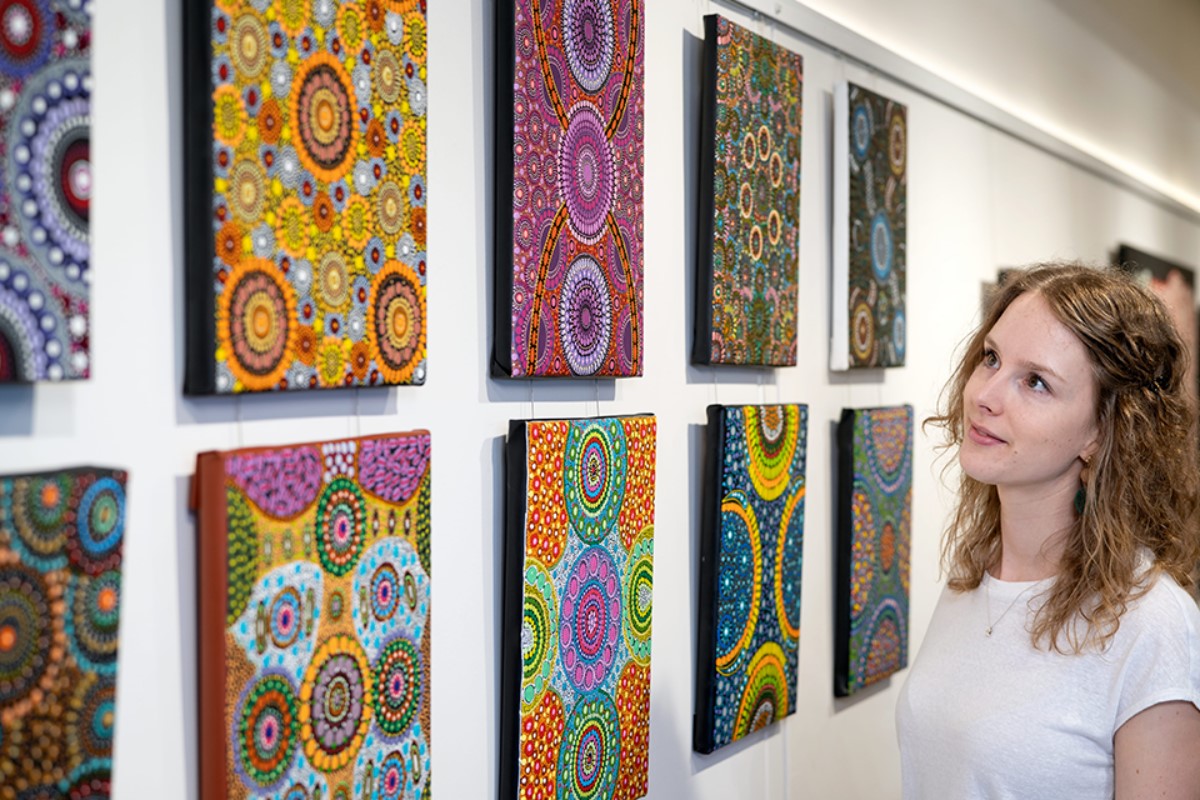 woman-looks-at-indigenous-art-gallery-nt-1200x800 Slide 2