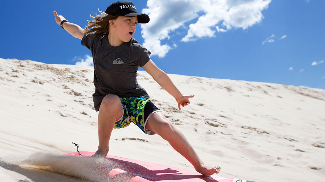 Child sandboarding Myall Shores Holiday Park my nrma local guides
