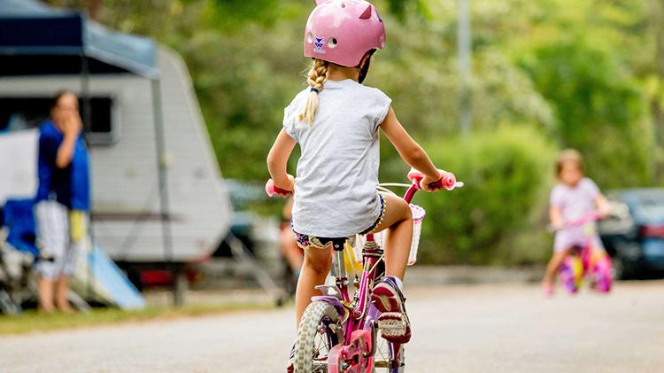 Child cycling on bike at NRMA Broulee Holiday Park