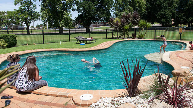 family relaxing poolside Bairnsdale Riverside Holiday Park Victoria my nrma local guides