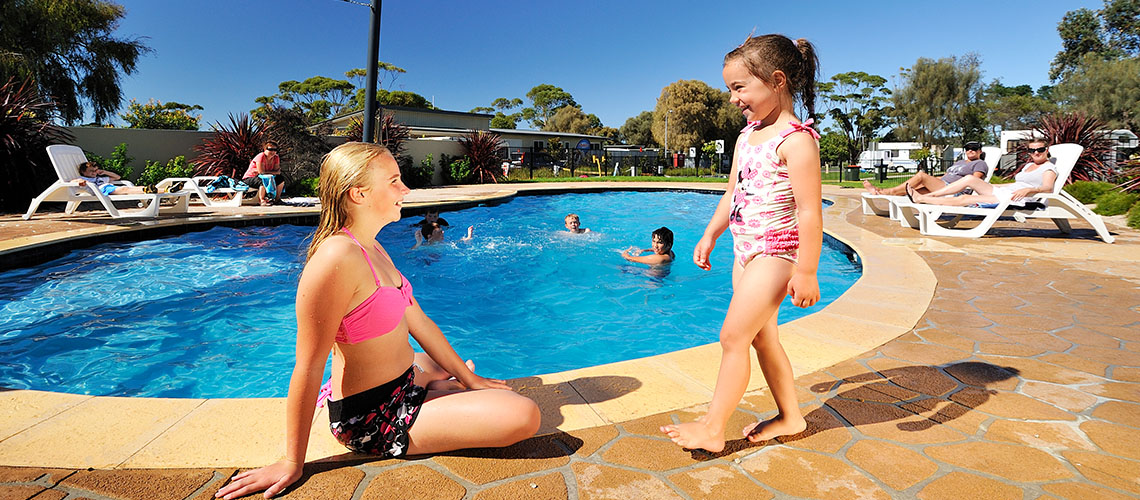 children relaxing near pool Eastern Beach Holiday Park Victoria my nrma local guides