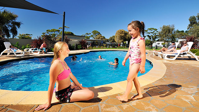 children relaxing near pool Eastern Beach Holiday Park Victoria my nrma local guides