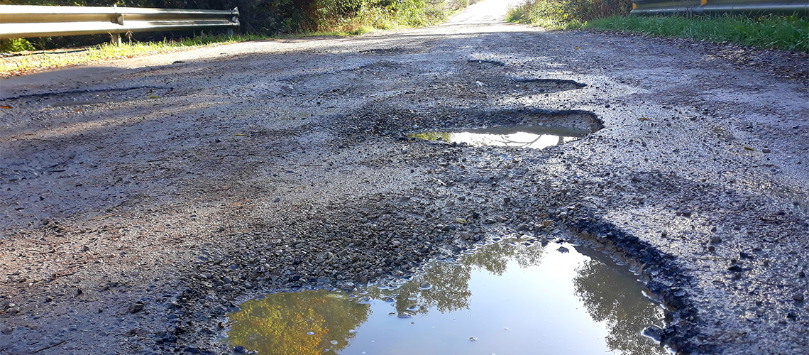 Pothole damaged road