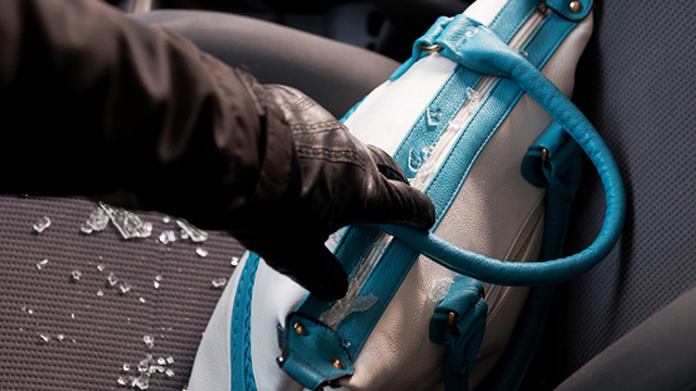 car break in robber grabbing handbag with glass shattered
