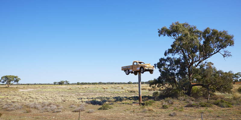 sculpture of a car on a pole