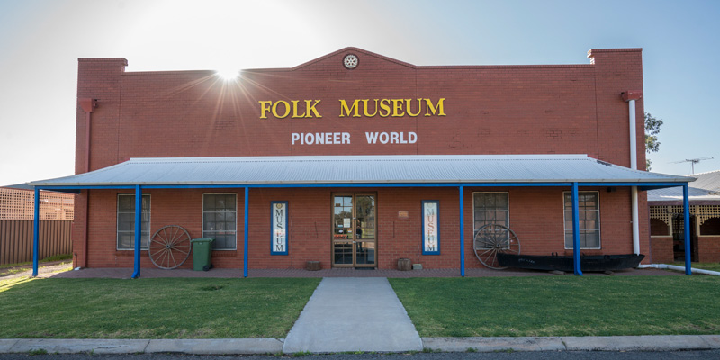 red brick building with the sign folk museum pioneer world