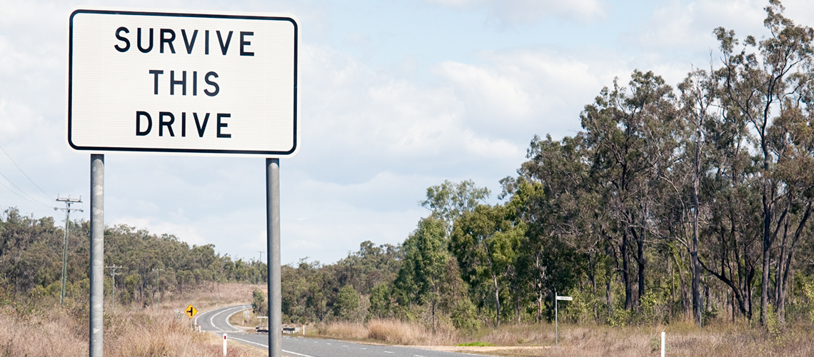 Road sign in rural Australia that reads 'Survive this drive"