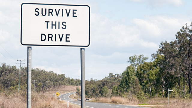 Road sign in rural Australia that reads 'Survive this drive"