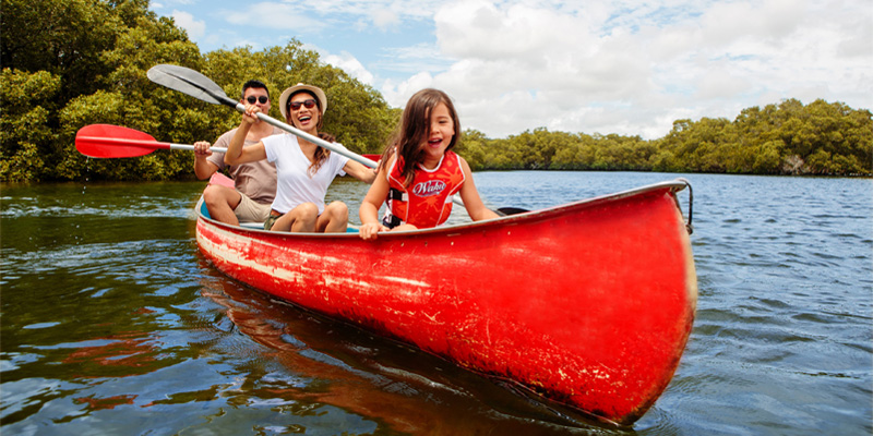 family canoeing in a red canoe in brunswick heads
