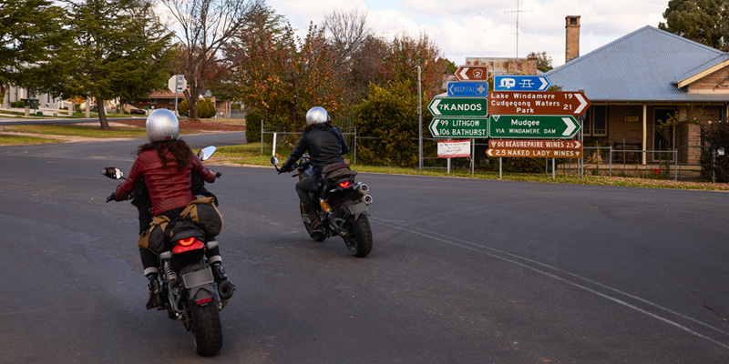 two motorcyclists riding through the town of rylstone