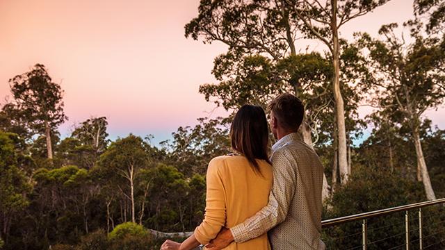 Couple enjoying sunset Cradle Mountain Hotel Balcony